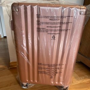 Calpak Ambeur 22” Carry On Luggage - Rose Gold